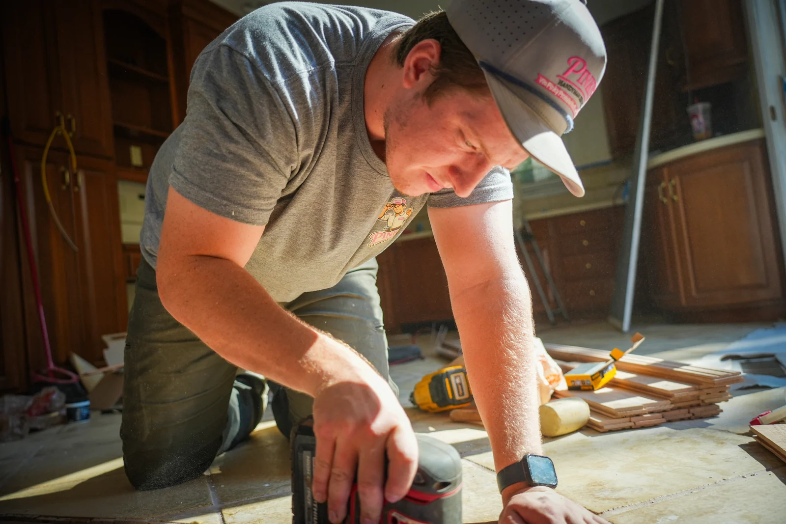 Pinky's Handyman craftsman sanding wood during an onsite content shoot